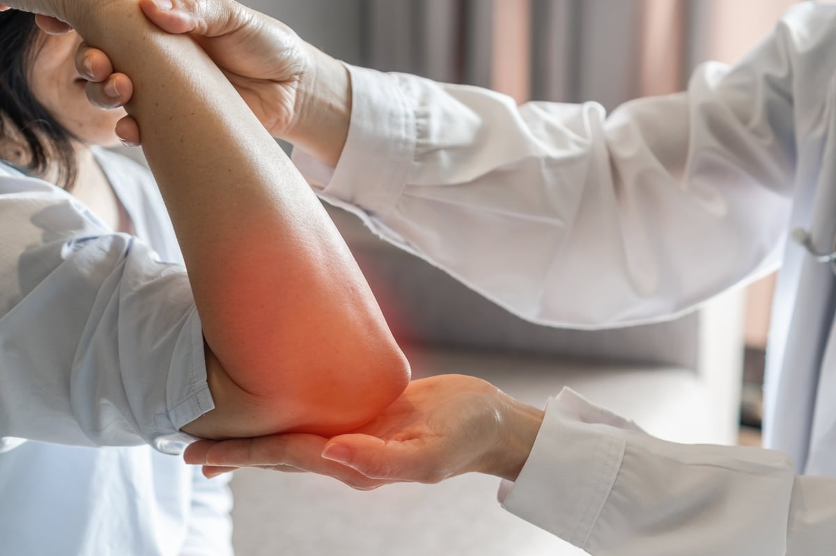 Patient having their elbow evaluated at an orthopedic clinic for ulnar nerve pain