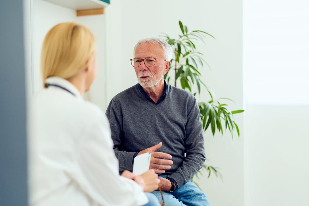 A patient speaking with their orthopedic surgeon during a thoughtful consultation about treatment options
